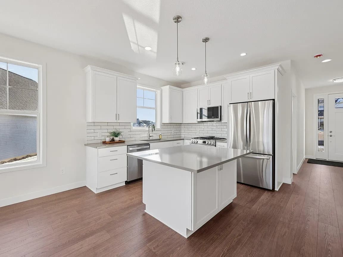 Custom home white kitchen with island in Buffalo, MN by Nordic Homes